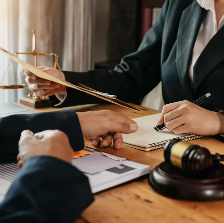 business-lawyers-discussing-contract-papers-with-brass-scale-desk-office-law-legal-services-advice-j