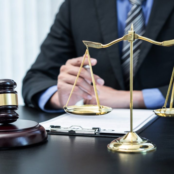 Male lawyer working with legal case document contract in office.